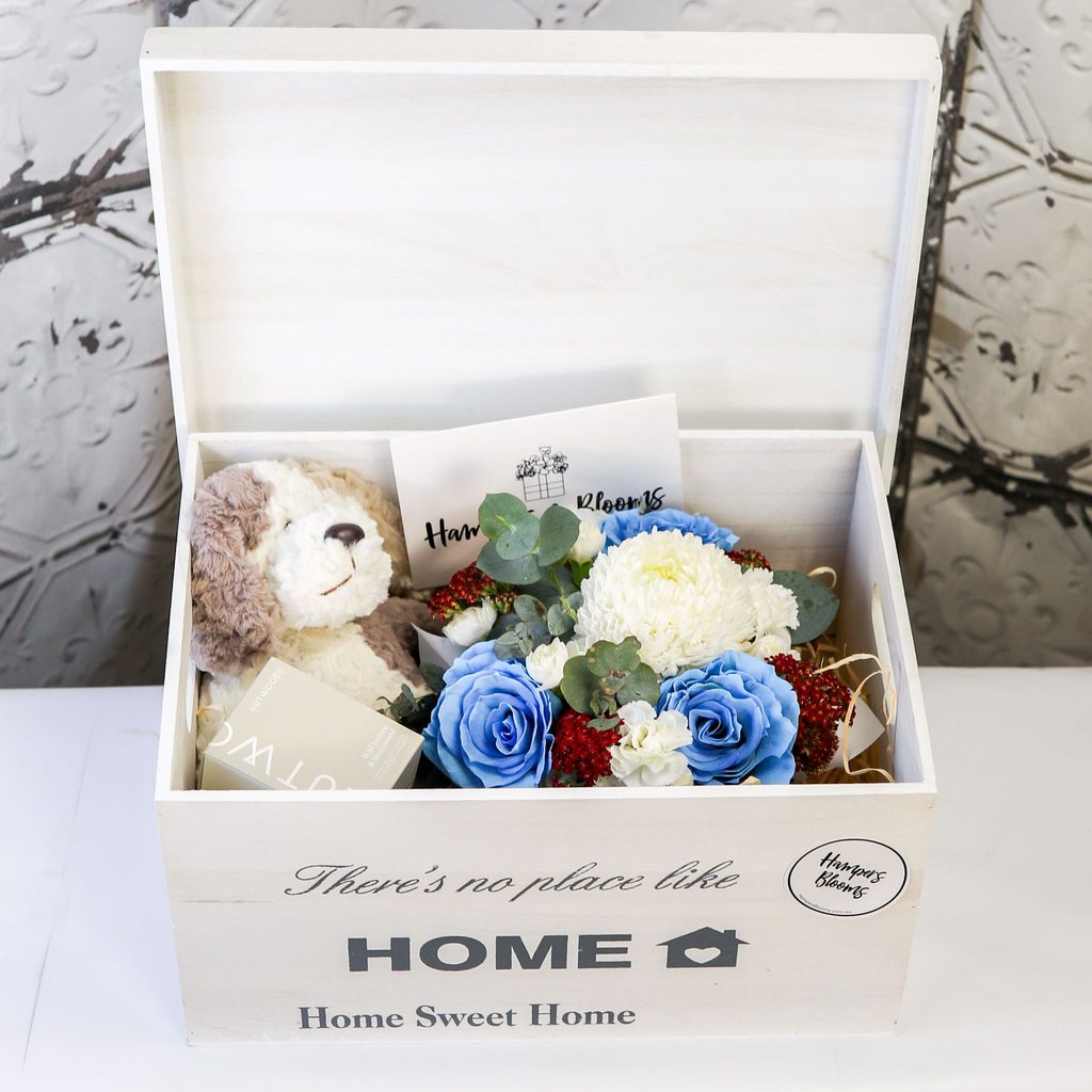 Welcome Baby keepsake chest with blue-tinted flowers and plush puppy